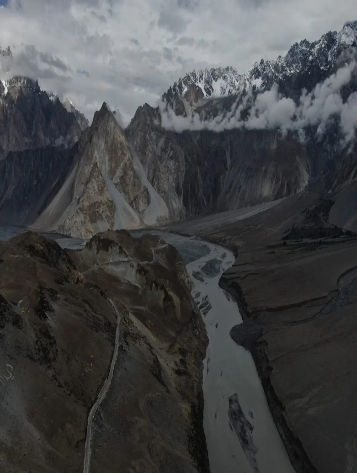 Aerial view of the Passu Cones with a braided glacial river and mountain road