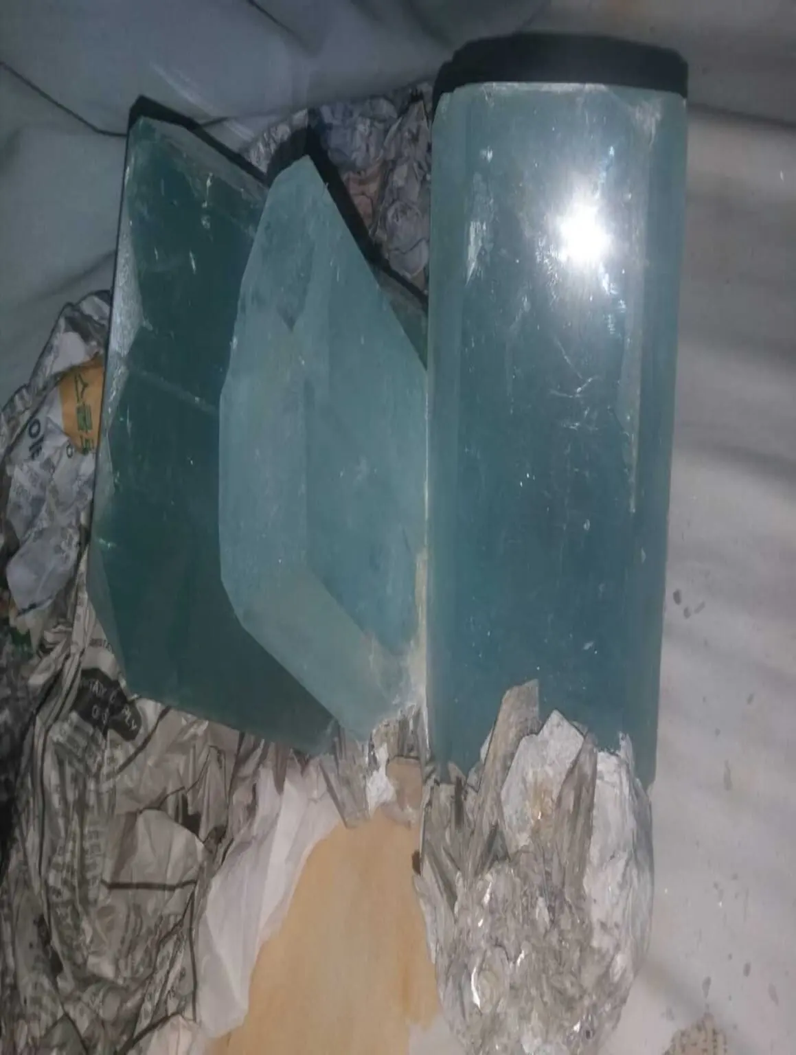 Large aquamarine crystals partially wrapped for transport